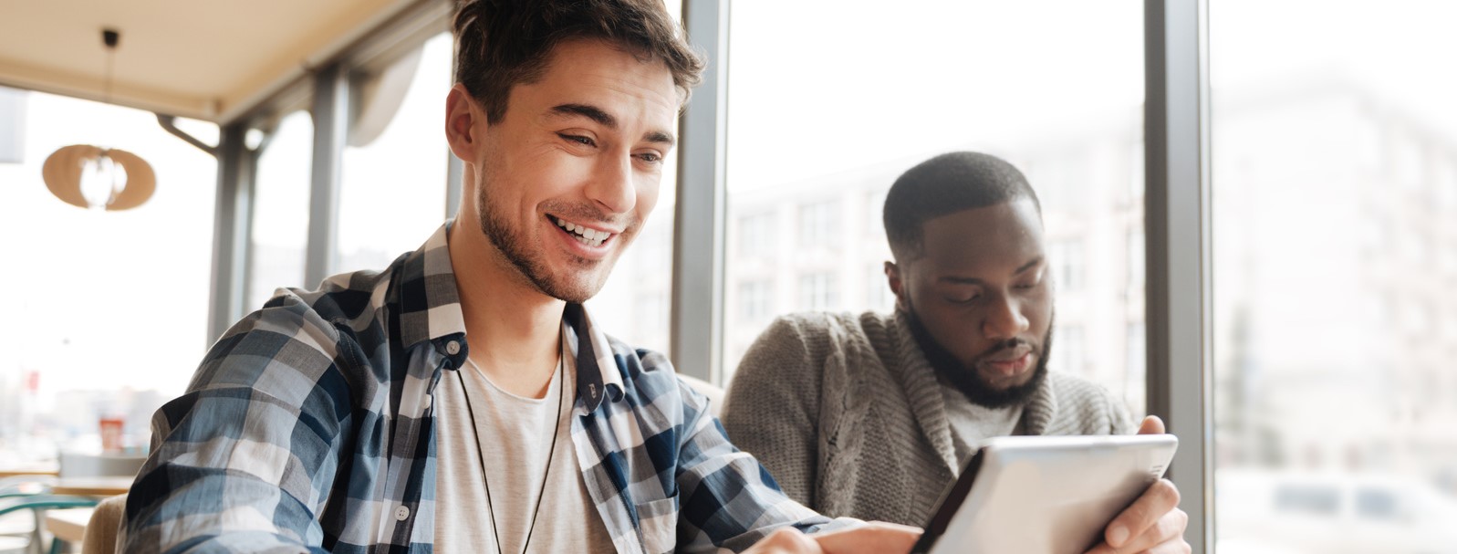 Two Students Working On Tablet Together