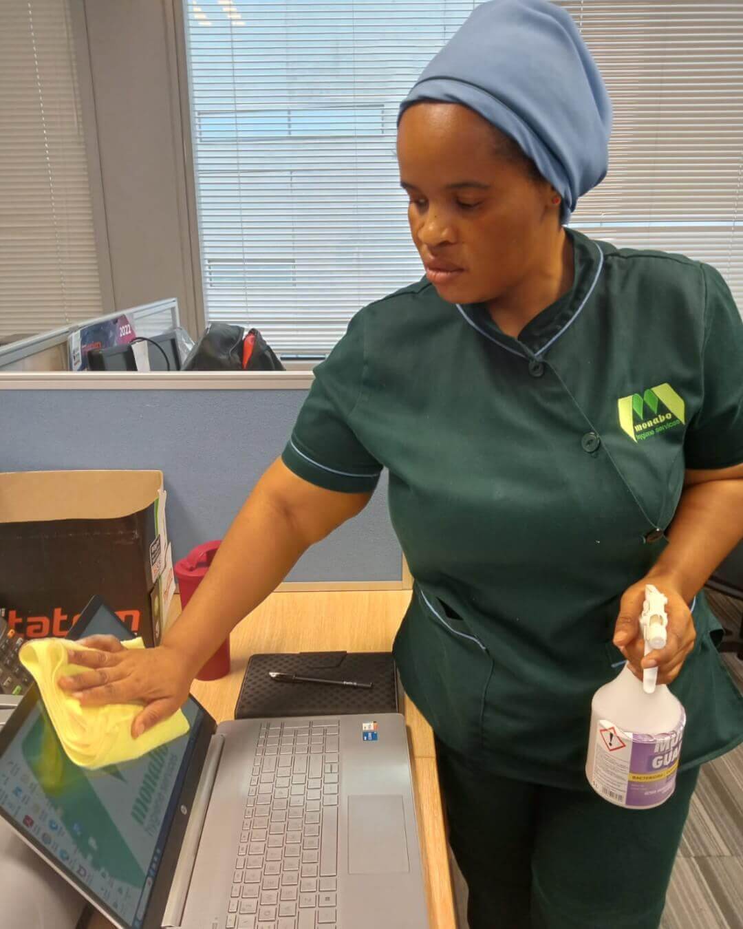 Cleaner Disinfecting An Office Computer Screen.