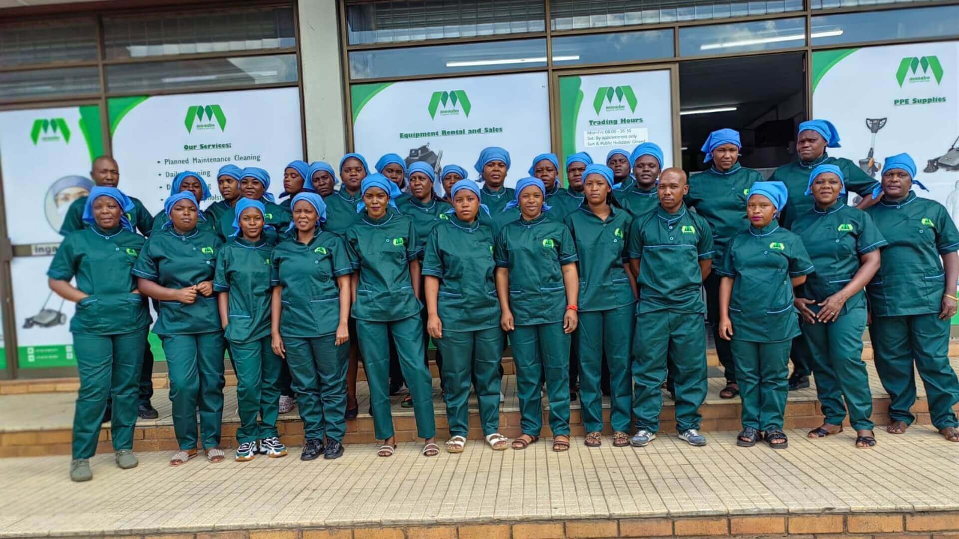 Large Group Of Cleaners Posing In Uniform.