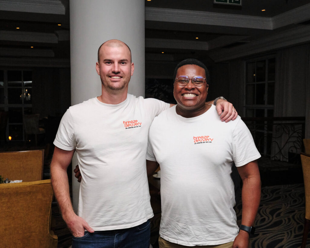 Two Colleagues Smiling Together At Corporate Networking Event.